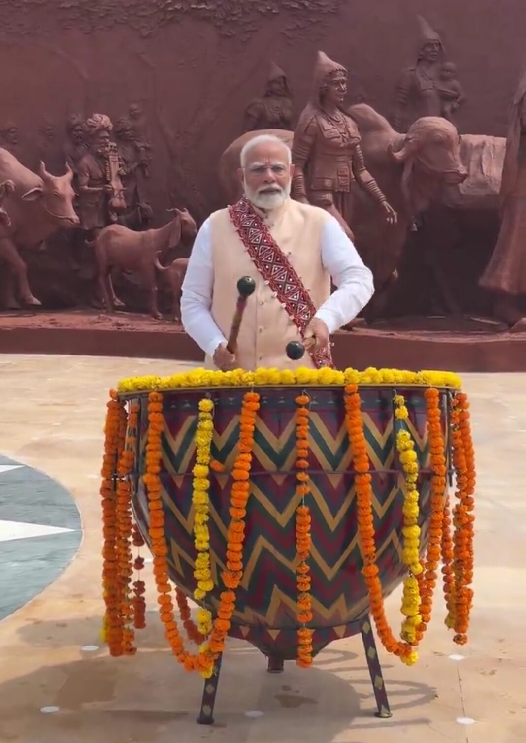Prime Minister tries his hand at the Nangara, a key musical instrument of the Banjara culture Prime Minister tries his hand at the Nangara, a key musical instrument of the Banjara culture